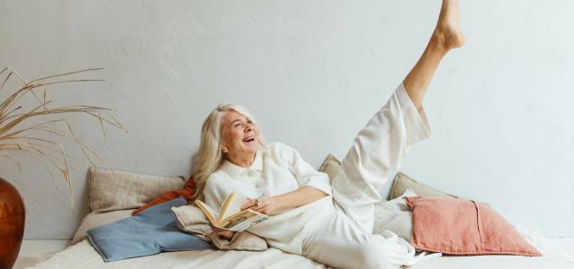 senior woman laughing on daybed